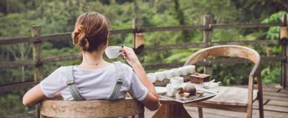 Participant learns about the ethical and sustainable production of coffee in Costa Rica. Woman enjoys a tasting of ethically produced coffee in Costa Rica.